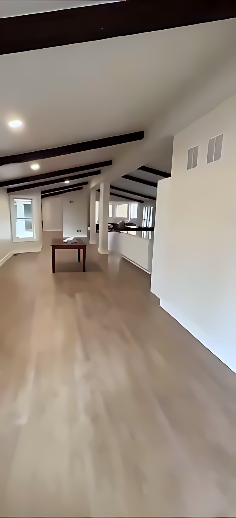 Bright hallway with black ceiling beams